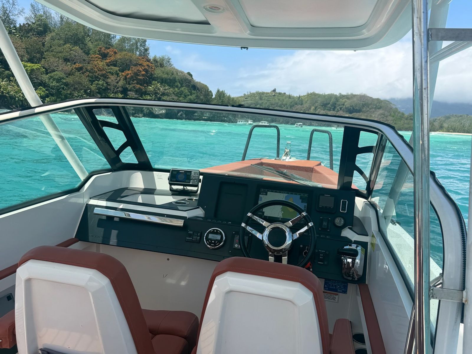 The helm and dashboard under the T-top